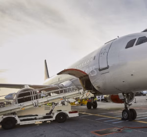 Aircraft baggage loading using a Power Stow conveyor at the airport apron