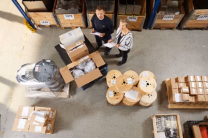Warehouse staff reviewing inventory and shipment documents
