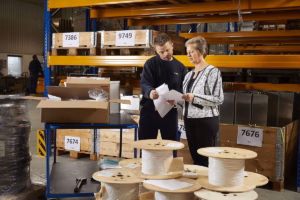 Warehouse staff reviewing inventory and shipment documents